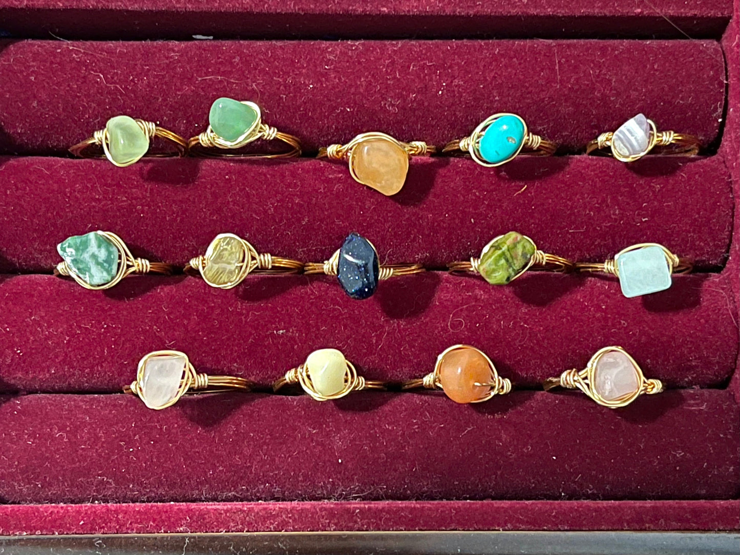 a collection of rings in a red velvet box