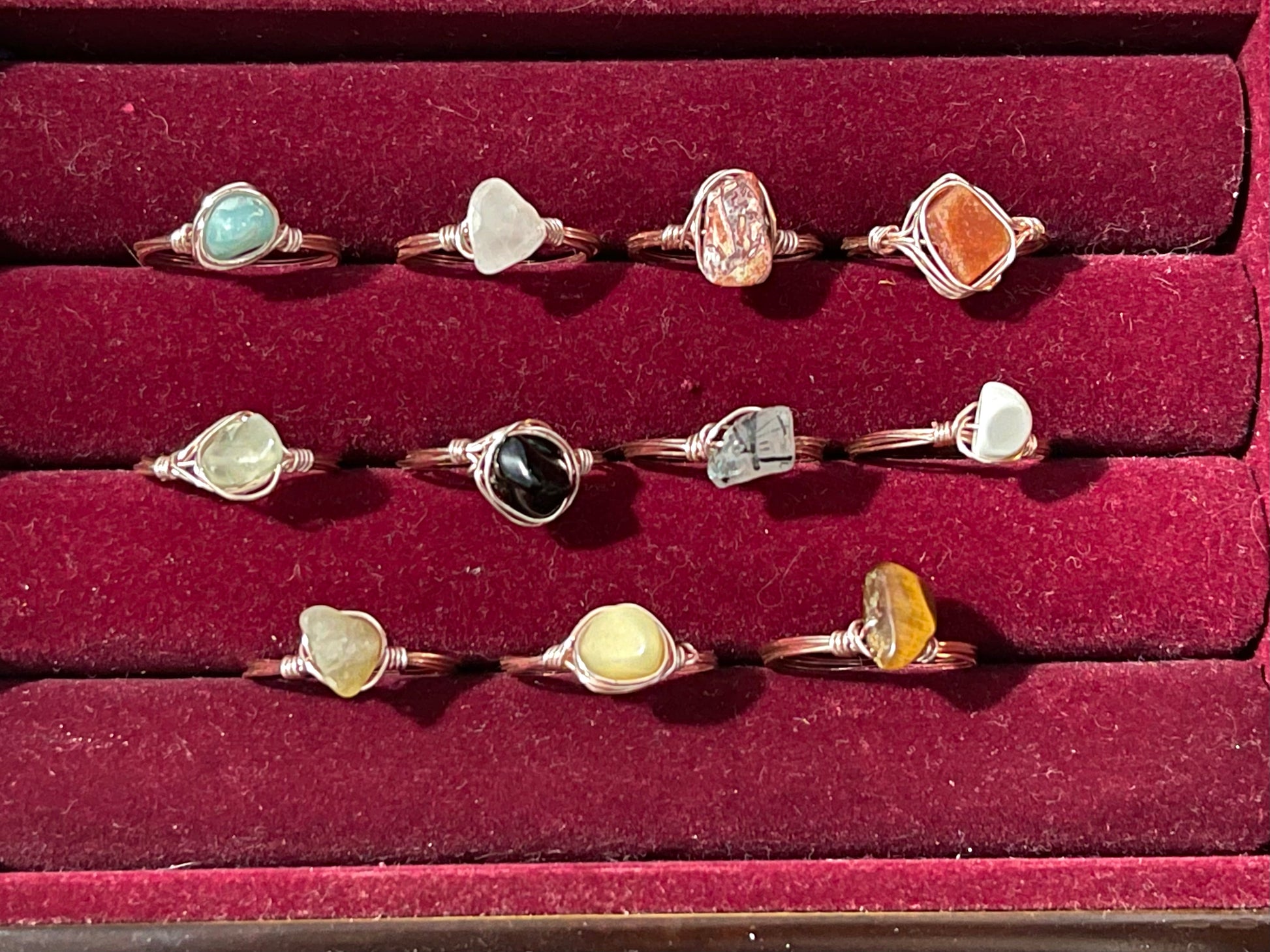 a collection of rings in a red velvet box